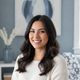 Portrait of a smiling young Latin American woman with smooth, shiny dark hair, looking confident and happy.